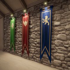 three different colored banners hanging on a stone wall