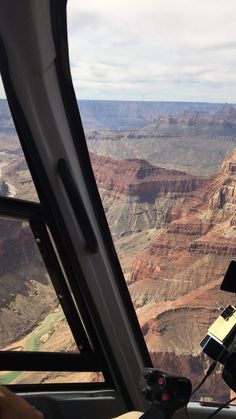 a view from inside a helicopter looking out over the grand canyon