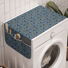 a washer and dryer sitting next to each other in front of a tiled wall