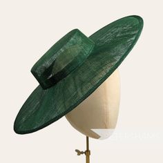 Boaters are all the rage, and this bottle green sinamay fascinator version has us all in a twirl!  Made from 2 layers of stiffened sinamay, these boaters are ready to trim and have a petersham ribbon on it's inside edge. Simply add a comb or headband to secure to the head. Hat base measures: Width: 36.5cm (14.4 inches) Crown Width: Please note that the crown is on the larger side, measures 16.5cm (6.5 inches) wide.  Crown Height: 4.5cm (1.7 inches) For even more millinery supplies you can find us here: www.etsy.com/shop/Petershams All orders are posted daily from London, England with expected delivery times of: Within the UK: 1-5 working days (by 1st Class Post) Outside the UK: 5-15 working days (by Standard Airmail) Upgraded traceable priority services are available for an extra cost, jus Adjustable Green Brimmed Boater Hat, Green Straw Hat With Curved Brim For Garden Party, Green Short Brim Straw Hat For Kentucky Derby, Green Curved Brim Straw Hat For Garden Party, Green Brimmed Straw Hat For Garden Party, Green Wide Brim Boater Hat For Kentucky Derby, Green Fitted Top Hat For Church, Fitted Green Top Hat For Church, Fitted Green Top Hat For Summer