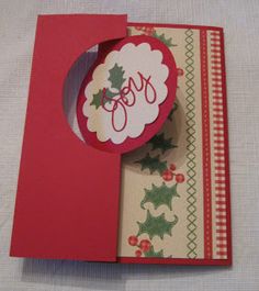 an open christmas card with holly on it