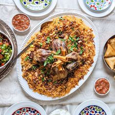 an overhead view of a plate of food on a table with other plates and bowls