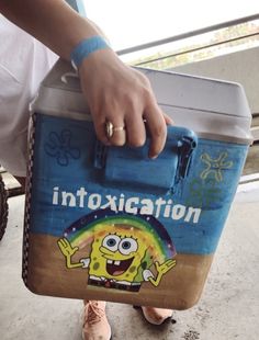 a person holding a bag with an image of a cartoon character on it