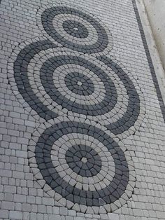 a brick sidewalk with circles on it