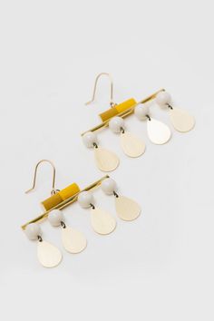 Porcelain & Brass Earrings - Crafted to captivate, Mary Hambys Make Your Move Earrings are more than mere accessories; theyre a reminder to stay daring and keep moving forward. Each earring features a hand-glazed porcelain cylinder perched atop a glimmering brass bar, all the while porcelain spheres and droplets of brass dance below. Lightweight yet substantial, they hang from gold-filled ear wires. Brass Bar, Contemporary Earrings, Keep Moving Forward, Earring Crafts, Keep Moving, Brass Earrings, Moving Forward, Ear Wires, Gold Filled