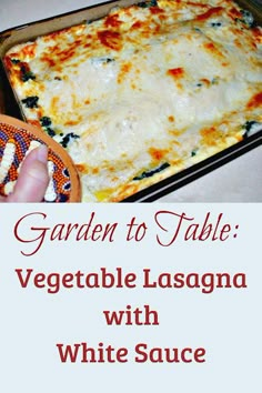 a casserole dish with white sauce and vegetables in it, on a table