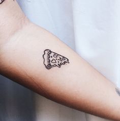 a person's arm with a piece of pizza tattooed on the left side of their arm