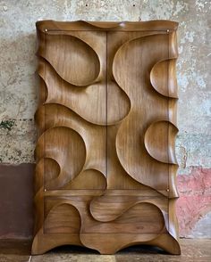 a wooden cabinet sitting on top of a tile floor