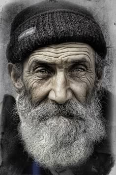 an old man with a long beard wearing a hat