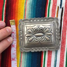 "This piece is a classic rectangular belt buckle with scalloped edges and lovely sterling silverwork. Great gift for an anniversary, birthday or an amazing wedding suit addition for a southwestern vibe. 49 grams for the entire piece 2.4\" long 3\" wide 2\" wide attachment for belt Signed by artist BLKGT and sterling silver hallmark. If you have questions about this item etc please ask before you purchase. Sold as-is, no returns or exchanges on any jewelry. Free domestic shipping Thanks for looki Classic Silver Buckle Belt As Gift, Handmade Western Belt Buckles For Gift, Elegant Silver Belt Buckles As Gift, Silver Concho Belt Buckles As Gift, Classic Silver Belt Buckles As Gift, Classic Silver Belt Buckle As Gift, Elegant Handmade Belt Buckles As Gifts, Silver Rectangular Belt Buckles For Formal Occasions, Classic Silver Buckle Belt Buckles As Gift