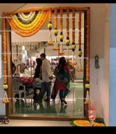 a man and woman walking in front of a mirror