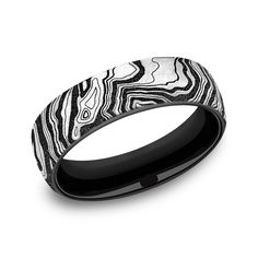 a wedding band that is black and white with an abstract design on the inside of it