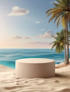 an empty round table sitting on top of a sandy beach next to the ocean and palm trees