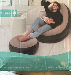 a woman is sitting in an inflatable chair