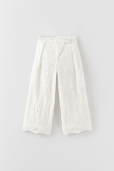 Pants with back elastic waistband and front crossover button closure. Swiss embroidery motif and uneven hem. WHITE | 1200/323 OUTER SHELL: 95% cotton · 5% polyester LINING: 100% cotton Elegant Broderie Anglaise Bottoms For Spring, Elegant White Bottoms With Broderie Anglaise, Elegant White Broderie Anglaise Bottoms, Spring Cotton Bottoms With Broderie Anglaise, Casual Cotton Bottoms With Broderie Anglaise, Casual Broderie Anglaise Bottoms For Spring, White Wide-leg Pants With Floral Embroidery, White Floral Embroidered Wide-leg Bottoms, White Ankle-length Pants With Floral Embroidery