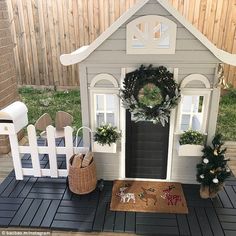 a dog house is decorated with wreaths and decorations