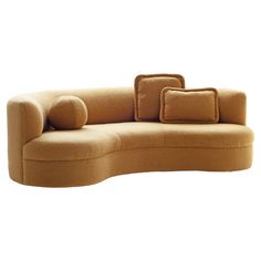 a curved couch with pillows on it