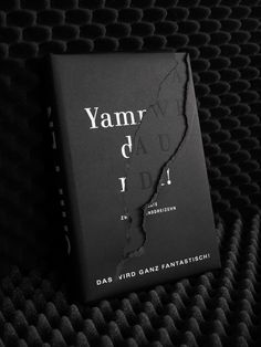 a book with the title yam d'i on it sitting on a black surface