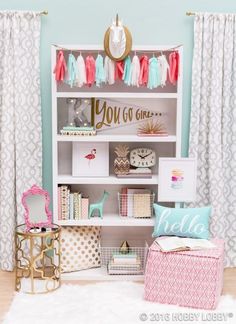 an image of a room that is decorated with pink, blue and white decor on the walls