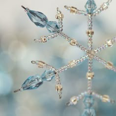 a snowflake made out of glass beads and swarong crystals is seen in this image