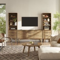 a living room filled with furniture and a flat screen tv on top of a wooden entertainment center