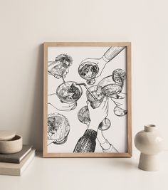 a black and white drawing on a wall next to a vase