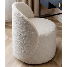 a white chair sitting on top of a hard wood floor