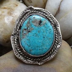 This is a Vintage Navajo Handmade Rustic Turquoise Pinky Ring SMALL SIZE 4 Stamp Decorated Sterling. This wonderful handcrafted rustic piece features a large beautiful turquoise stone with dark matrix and quartz surrounded by rope twist wire and an edged stamped back plate. The shank is cold chisel split. The ring is a SMALL SIZE 4 and is suitable as a pinky ring or small finger. Condition: vintage Size: 4 Metal: 925 Sterling Silver (tested) Surface: vintage patina Measurement: 1 1/8 x 1 inches Weight: 6.6 grams Hallmark: none/unsigned Tribal Affiliation: Navajo Comments: comfortable fit as a pinky ring #2452335 Bohemian Oval Turquoise Ring For Jewelry Making, Rustic Turquoise Jewelry, Artisan Turquoise Ring With Natural Stones, Adjustable Rustic Turquoise Ring, Unique Handmade Turquoise Ring, Turquoise Ring With Large Stone For Jewelry Making, Rustic Adjustable Turquoise Ring, Southwestern Turquoise Rings With Patina, Artisan Turquoise Ring Untreated