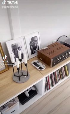 there is a stereo on top of a shelf in the room with pictures and other items