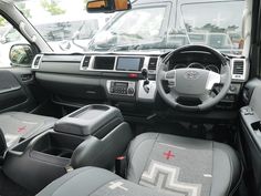 the interior of a vehicle with grey leather seats