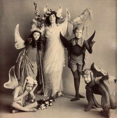 an old black and white photo of people dressed up as fairy dusters with wings