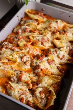 a casserole dish filled with meat and cheese