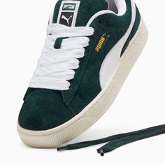 This fresh take on the classic Suede draws inspiration from PUMA’s Y2K-inspired style and its influence on modern streetwear. The Suede XL retains the Suede’s iconic DNA, but gives it a twist with an exaggerated padded collar and tongue, plus a chunkier sole. This version comes with a hairy suede upper that creates a unique look. PUMA’s leather products support responsible manufacturing via the Leather Working Group.www.leatherworkinggroup.com Hairy suede upper Thick laces CPU badge on tongue and debossed and printed PUMA branding Synthetic lining Synthetic sockliner PUMA branding on outsole Rubber midsole Rubber outsole Classic Green Sneakers For Streetwear, Classic Green Custom Sneakers For Streetwear, Modern Custom Sneakers With Gum Sole For Streetwear, Modern Skate Shoes With Gum Sole For Streetwear, Urban Streetwear Custom Sneakers, Trendy Custom Sneakers With Gum Sole For Streetwear, Retro Green Custom Sneakers For Streetwear, Urban Green Skate Shoes For Streetwear, Green Urban Custom Sneakers For Streetwear