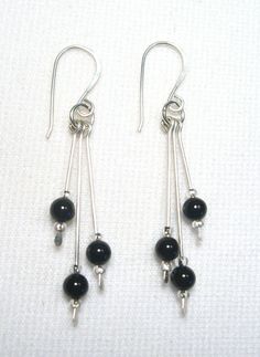 These earrings are Black Onyx.  Their overall length including earwires is about 2". The Onyx drops are 4 mm stones. They are Sterling Silver. Handmade by us.  Lyn's Jewelry, in business operating out of Sunny Syracuse since 1989. A family owned and operated business. Check us out. Black Sterling Silver Drop Crystal Earrings, Onyx Silver Earrings, Black Artisan Drop Earrings, Black Onyx Teardrop Earrings, Silver Onyx Drop Earrings, Drop Earrings Silver, Business Check, Jewelry Black, Handcrafted Artisan Jewelry