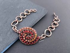 This beautiful unique bracelet, all handmade has a two colors seed bead swirl as a focal point. It closes with a hook clasp, also handmade. I love the look of oxidized copper, it gives a rustic, ancient look and enanches the copper warmth. The orange and red seed beads gives a pop of color to this unique bracelet. The focal point has 4.5 cm x 2,5 cm/ 1.7 in x 1 in. The chain bracelet measures 19 cm/ 7.5 inches in the last link. Links can be added or withdrawn if needed, just leave your bracelet Drilling Glass, Bubble Earrings, Unique Jewelry Gifts, Oxidized Copper, Creating Jewelry, Unique Bracelets, Bead Chain, Copper Necklace, Copper Bracelet