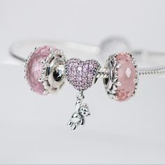 This is charm only, bracelet is sold separately. Bring some extra joy and sparkle to your Valentine's Day with this exquisite heart and teddy bear combo charm. Perfect for adding to a bracelet or necklace, this solid 925 sterling silver charm features a dazzling pink cubic zirconia pave heart and a tiny teddy bear for a touch of cuteness. Show your love with this adorable charm, plated with shiny platinum to keep it shining for years to come. Materials: 925 sterling silver, cubic zirconiaFinish: platinum plateDimensions: 0.82 x 0.42 x 0.30 inHole size: 0.18 in Jewelry Care: See more information about how to care for your jewelry here. Shipping Policy: Orders will be shipped within 1-3 business days. Economy shipping will take 7-14 days to arrive and standard shipping is 1- 4 days for U.S. Cute Pink Sterling Silver Jewelry, Pink Charm Bracelet For Birthday, Pink Heart-shaped Dangling Charms, Pink Heart Pendant Charms As Gift, Pink Heart Charm Bracelet In Sterling Silver, Personalized Pink Sterling Silver Charm Bracelet, Pink Heart-shaped Sterling Silver Charm Bracelet, Pink Sterling Silver Charm Bracelet With Heart, Pink Heart-shaped Sterling Silver Bracelets