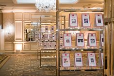 a room filled with lots of framed pictures and chandelier