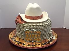 a cowboy hat on top of a wooden board