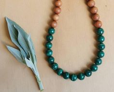 "A stunning set of ethnic style wooden beads.  This necklace is made up of beautiful, vibrant green  Malachite and Aromatic Sandalwood beads. Healing properties of Malachite 💚 Malachite is a beautiful heart chakra crystal, benefiting both the emotional and physcical heart.  It assists one in finding the joy in life.  It also benifits the solar plexus, promoting alignment and expression of both personal and divine will. Its energy reminds us that we are co creators in this world and that the pos Traditional Green Necklace For Meditation, Nature-inspired Green Jewelry With Wooden Beads, Green Spiritual Necklace With Wooden Beads, Spiritual Green Necklace With Wooden Beads, Earthy Green Necklace With Wooden Beads, Traditional Green Beaded Necklaces With Wooden Beads, Traditional Green Beaded Necklace With Wooden Beads, Green Polished Beads Mala As Gift, Green Polished Beads Mala For Gift