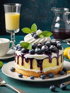 a cake with blueberries and whipped cream is on a plate next to glasses of orange juice