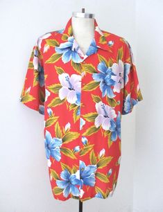 Cool vintage 1970's or 80's red, purple, blue and yellow tropical floral Hawaiian shirt from Paul Howard, California. Lightweight, nicely soft, likely all cotton, possibly a cotton blend. Features left chest pocket. APPROXIMATE MEASUREMENTS in inches - lying flat Size:  Unknown, likely 2XL Shoulder to shoulder:  22 Chest, armpit to armpit:  30 Waist:  29 Length, center back:  33.5 CONDITION Good to very good vintage condition with light typical wear. Red Collared Hawaiian Shirt For Beach, Red Hawaiian Shirt With Camp Collar For Spring, Red Collared Hawaiian Top, Vintage Red Camp Shirt With Camp Collar, Red Collared Top For Beach, Red Collared Top For The Beach, Red Relaxed Fit Hawaiian Shirt For Spring, Red Hawaiian Tops For Spring, Summer Red Camp Shirt For Vacation