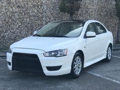 a white car parked in a parking lot