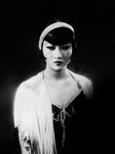 black and white photograph of a woman wearing a headband