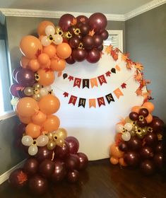 an arrangement of balloons and streamers on a table