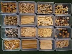 several plastic containers filled with lots of different types of matches