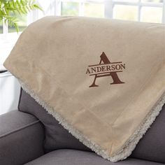 the personalized blanket is on top of a couch