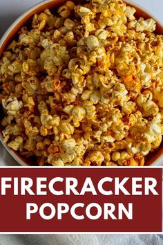 a bowl filled with popcorn sitting on top of a white table next to a red sign that says firecracker popcorn