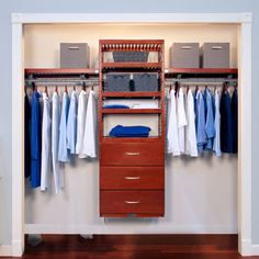 an organized closet with drawers and hanging clothes