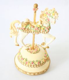 a figurine of a carousel horse with flowers on it