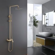 a bathroom with a sink, mirror and shower head on the wall next to it